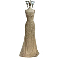 A beaded nude elegant sling luxury gown featuring a shimmering gold mermaid silhouette with intricate sequin patterns