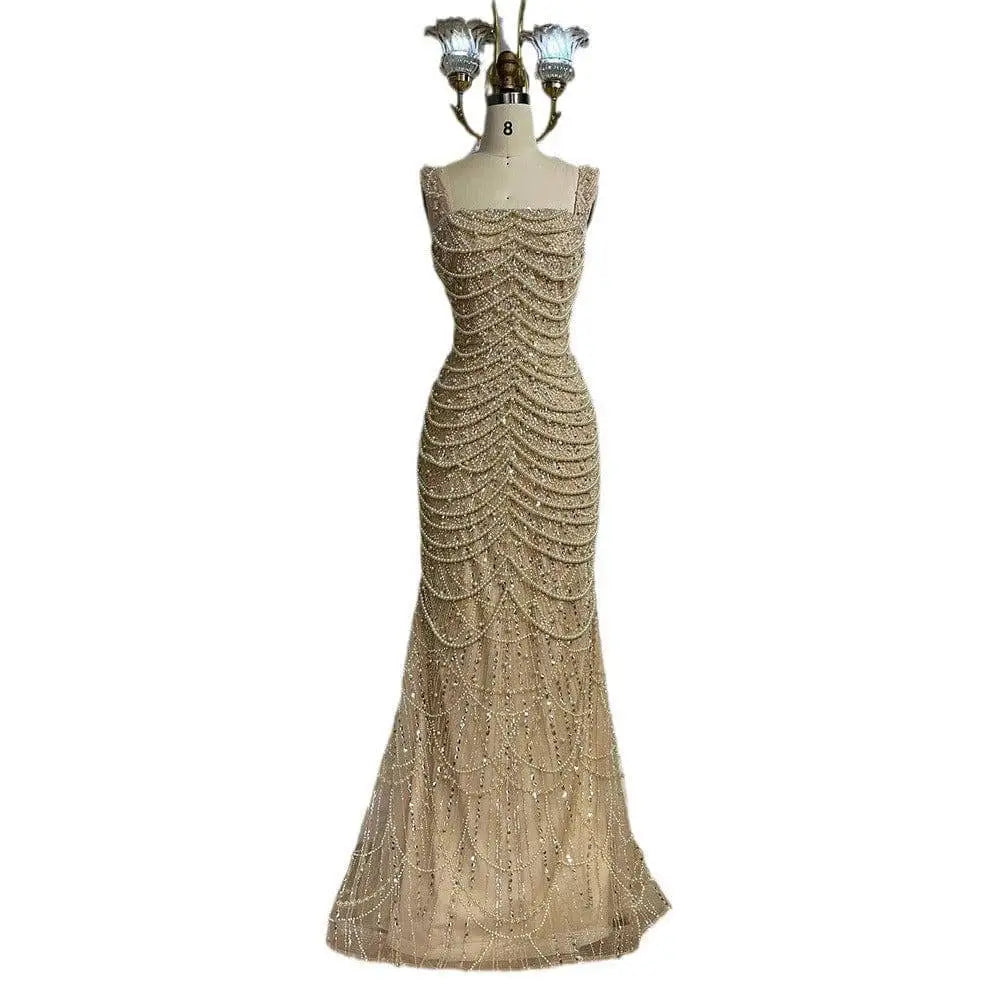A beaded nude elegant sling luxury gown featuring a shimmering gold mermaid silhouette with intricate sequin patterns