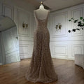 A shimmering gold beaded nude elegant sling luxury gown featuring a fitted bodice and flowing mermaid skirt on mannequin