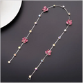 Beaded pink floral wedding hair accessories featuring a delicate silver chain with clear crystal accents