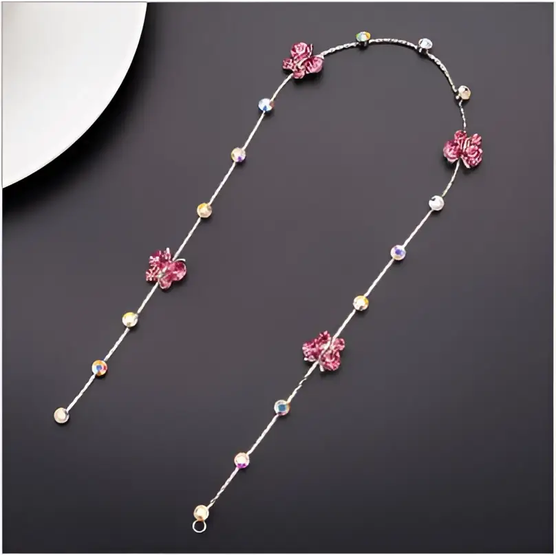 Beaded pink floral wedding hair accessories featuring a delicate silver chain with clear crystal accents