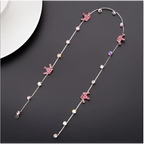 Beaded pink floral wedding hair accessories featuring a delicate silver chain with pink unicorn charms and clear crystals