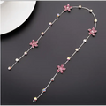 Beaded pink floral wedding hair accessories featuring a delicate silver chain with pink crystal flowers and pearls