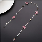 Beaded pink floral wedding hair accessories featuring a delicate silver chain with pink crystal flowers and pearls