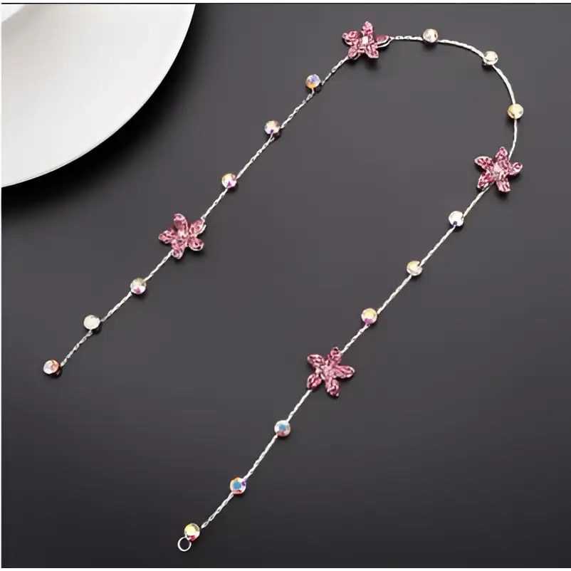 Beaded pink floral wedding hair accessories featuring a delicate silver chain with pink crystal flowers and pearls
