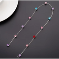 Delicate silver chain wedding hair accessories with beaded pink floral design and colorful faceted gemstones