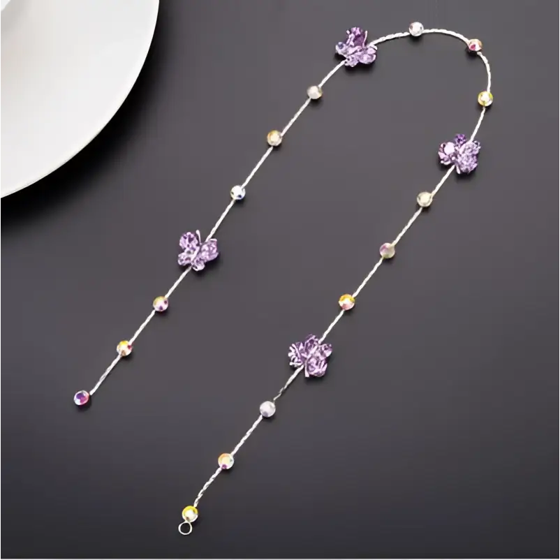 Beaded pink floral wedding hair accessories featuring a delicate silver chain with purple butterfly charms and pearls