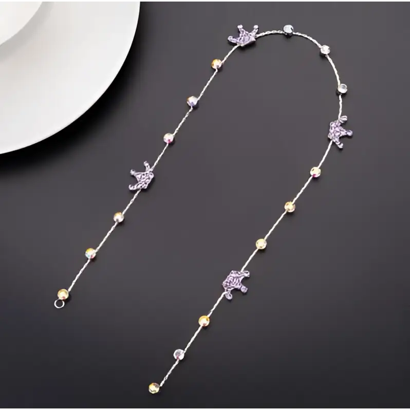 Beaded pink floral wedding hair accessories with a delicate silver chain featuring purple and clear gemstones and star charms