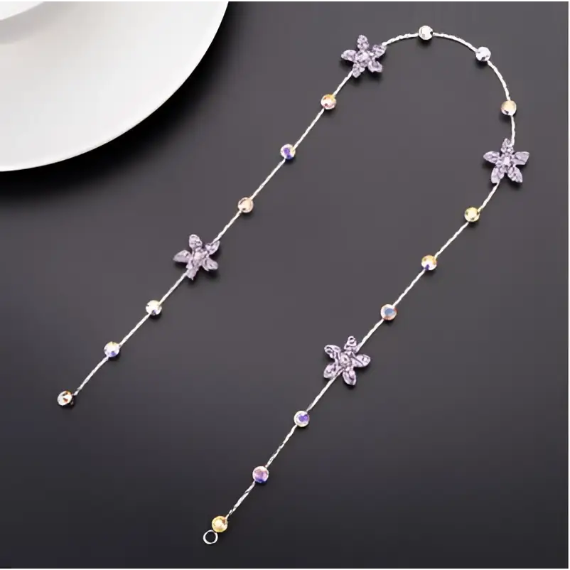 Beaded pink floral wedding hair accessories featuring a delicate silver chain with purple and clear crystal flowers