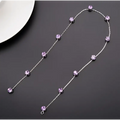 Beaded pink floral wedding hair accessories with a delicate silver chain necklace featuring faceted lavender crystals