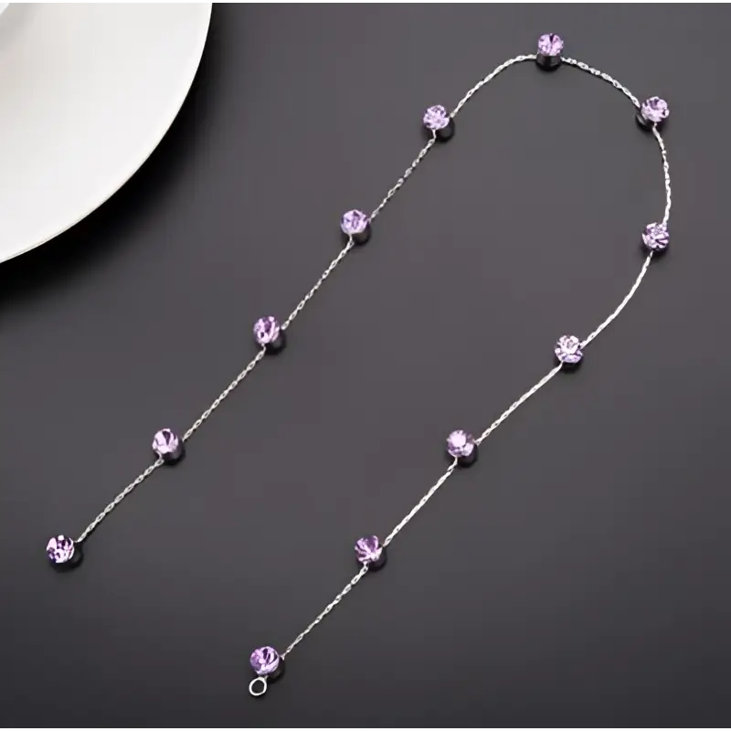 Beaded pink floral wedding hair accessories with a delicate silver chain necklace featuring faceted lavender crystals