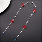 Beaded pink floral wedding hair accessories featuring a delicate silver chain with red floral charms and pearls