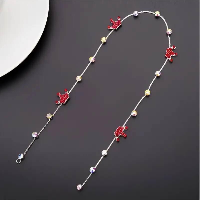 Beaded pink floral wedding hair accessories featuring a delicate silver chain with red enamel cherub charms and clear crystals