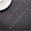 Beaded pink floral wedding hair accessories featuring a delicate silver chain with sparkling pink crystal beads
