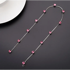 Beaded pink floral wedding hair accessories featuring a delicate silver chain with sparkling pink crystal beads