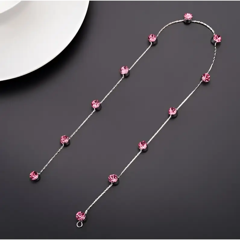 Beaded pink floral wedding hair accessories featuring a delicate silver chain with sparkling pink crystal beads