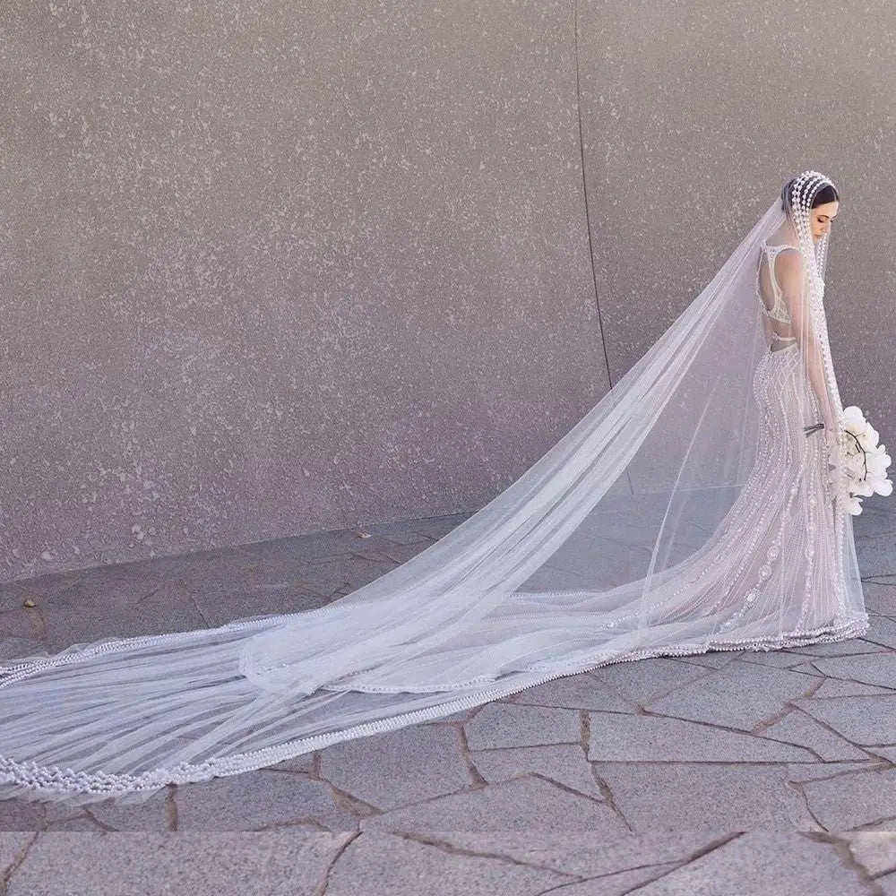 A long white yarn wedding bridal veil with delicate beaded trailing yarn edge and broadband hair comb headpiece