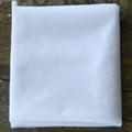 A crisp white lightweight mesh fabric folded square for beaded trailing yarn wedding bridal veil with broadband hair comb