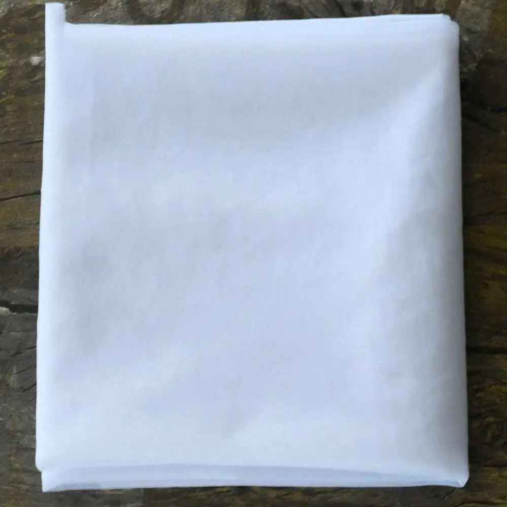 A crisp white lightweight mesh fabric folded square for beaded trailing yarn wedding bridal veil with broadband hair comb