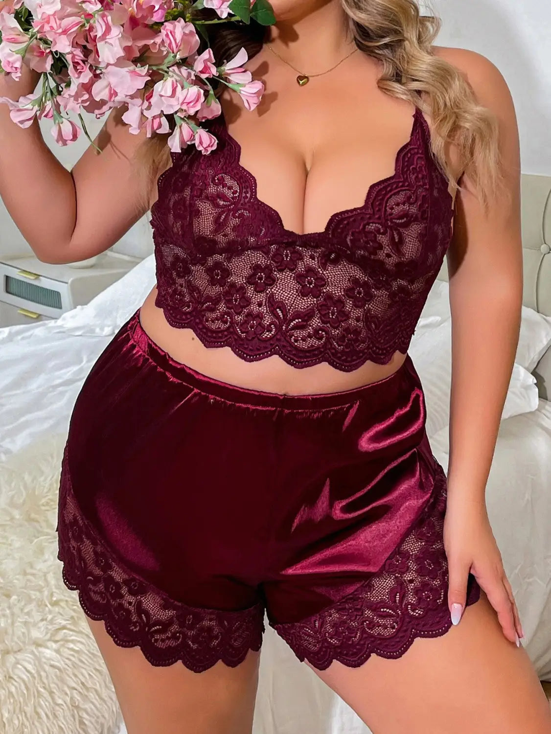 A maroon lace strap plus size two-piece suit featuring a floral-patterned satin bralette with scalloped edges and matching shorts with delicate lace trim.