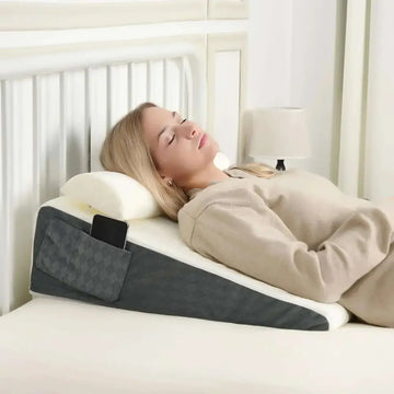 Gray and white wedge-shaped bed wedge pillow with textured pocket for smartphone designed for sleep apnea and acid reflux