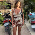 A woman wearing a beige 2pcs printed summer sexy halter suit with abstract print and thin straps