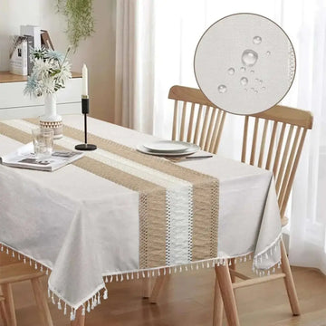 Beige and white woven x55 inch rectangle waterproof tablecloth with tassel trim for elegant dining protection