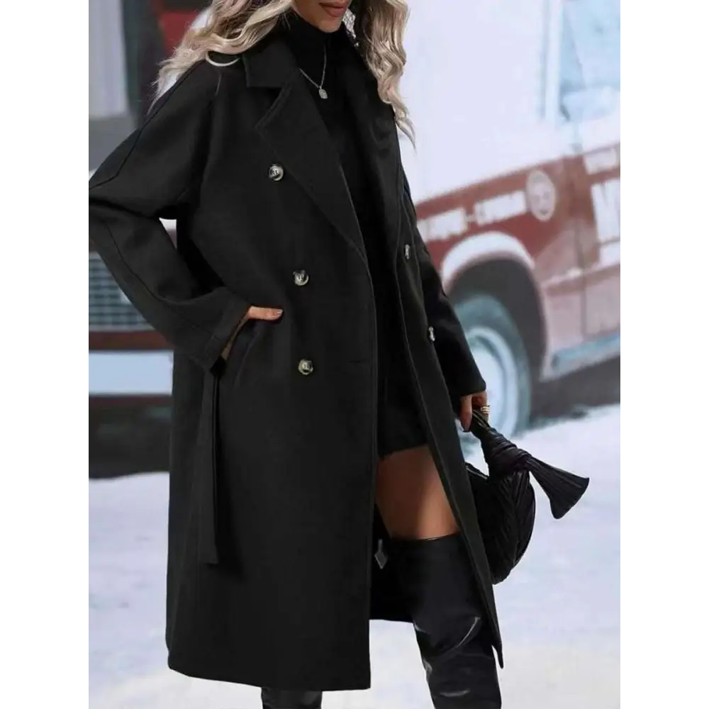 Black double breasted trench coat with silver buttons and belted waist for stylish belt winter fashion use