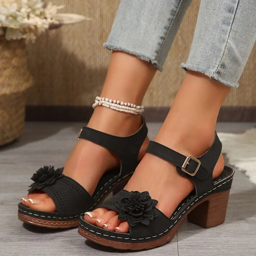 Beige floral flowers chunky heel sandals with black floral embellished perforated upper and wooden wedge heel