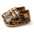 Beige leather baby casual shoes with leopard print, tan laces, and soft brown interior for baby casual shoes