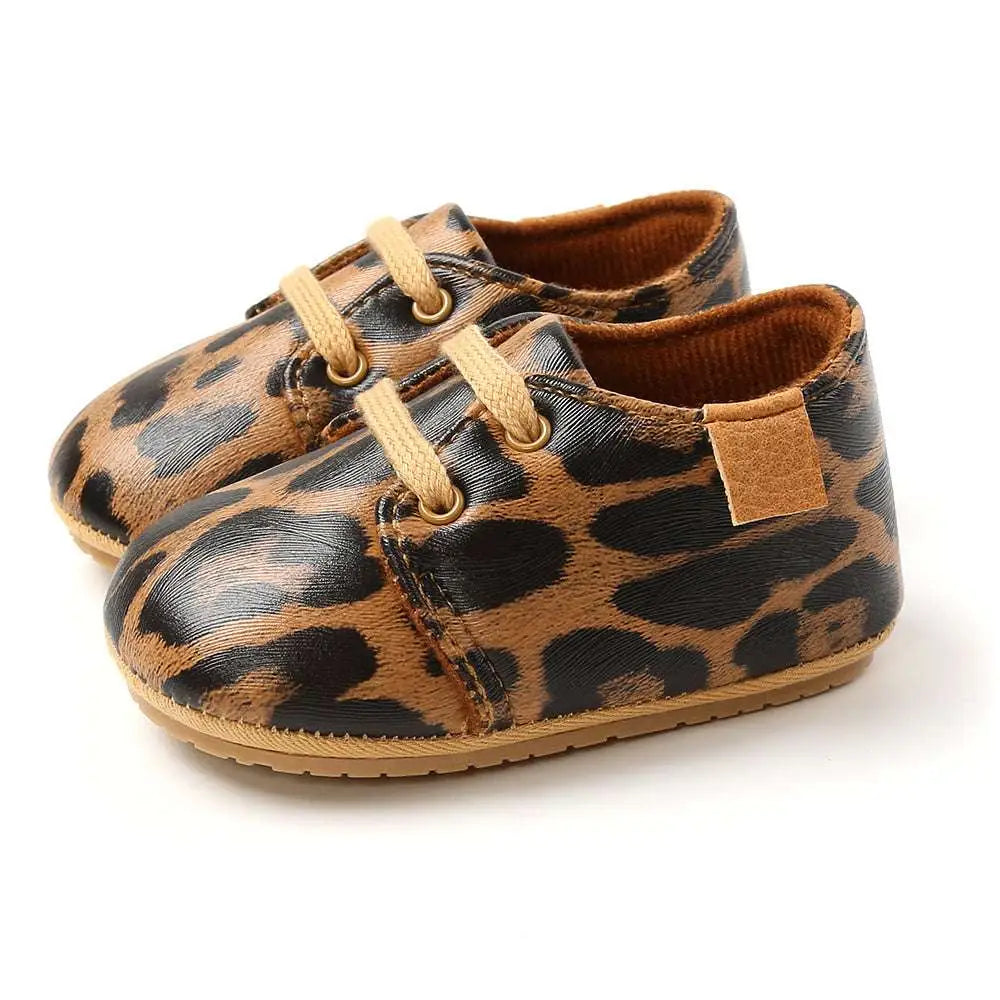 Beige leather baby casual shoes with leopard print, tan laces, and soft brown interior for baby casual shoes
