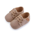 Beige leather baby casual shoes featuring tan leather baby shoes with matching laces and a small brown side patch