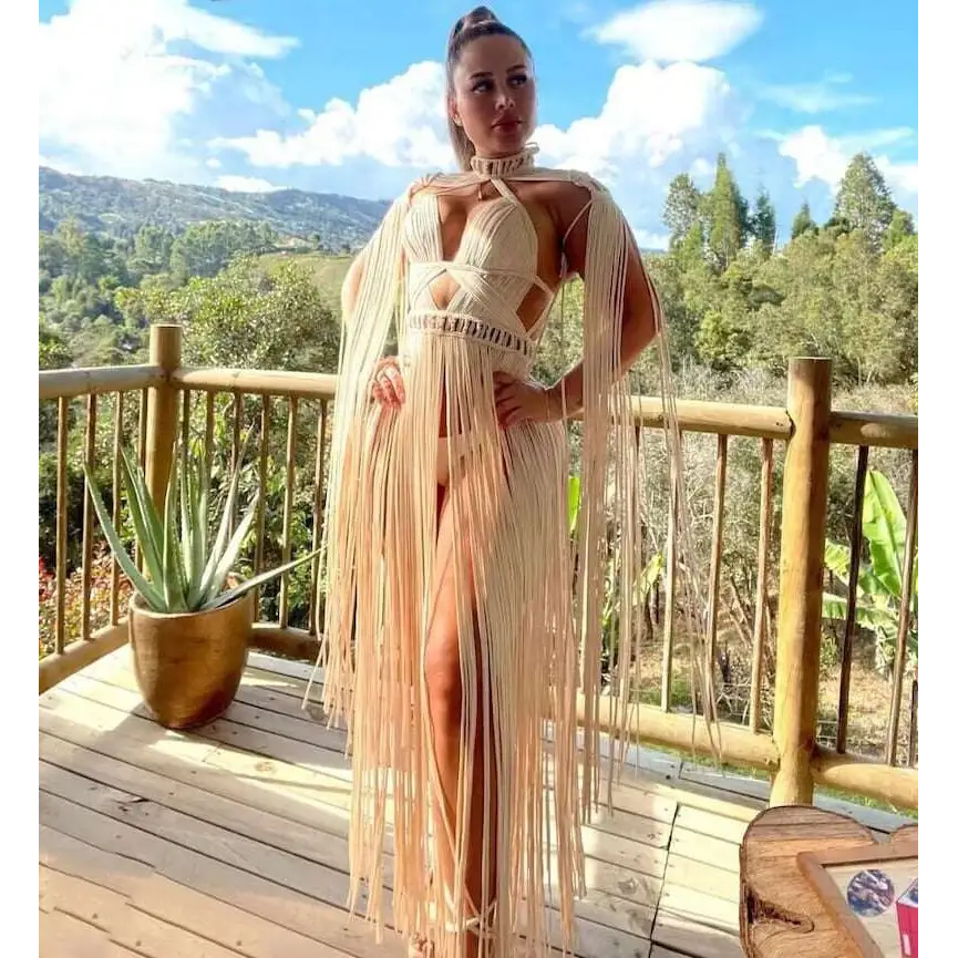 Beige macramé tassel dress featuring a cut-out bodice and long flowing fringe for creative beach travel look