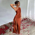 Beige one-shoulder backless slit satin gown with draped bodice and high slit in sleek elegant design