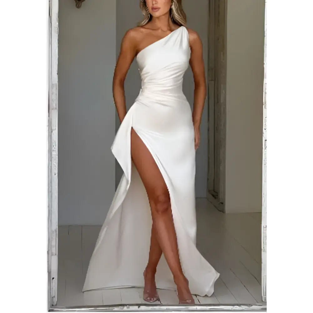 A sleek white satin one-shoulder backless slit gown featuring a draped bodice and high slit