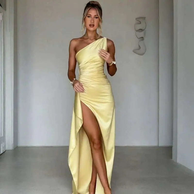 A sleek yellow satin one-shoulder backless slit gown with draped bodice and high slit design