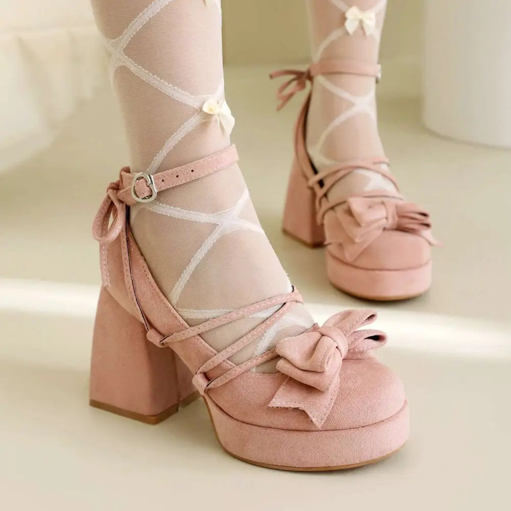 Beige suede platform lolita heels with ankle strap, chunky heel, decorative bows, and lace-up detailing