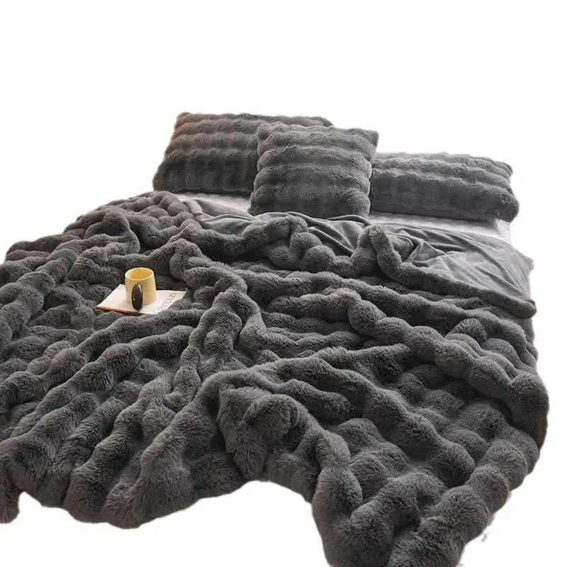 A plush dark gray faux fur throw blanket with chunky knit texture, a velvet blanket thickened for warmth and comfort