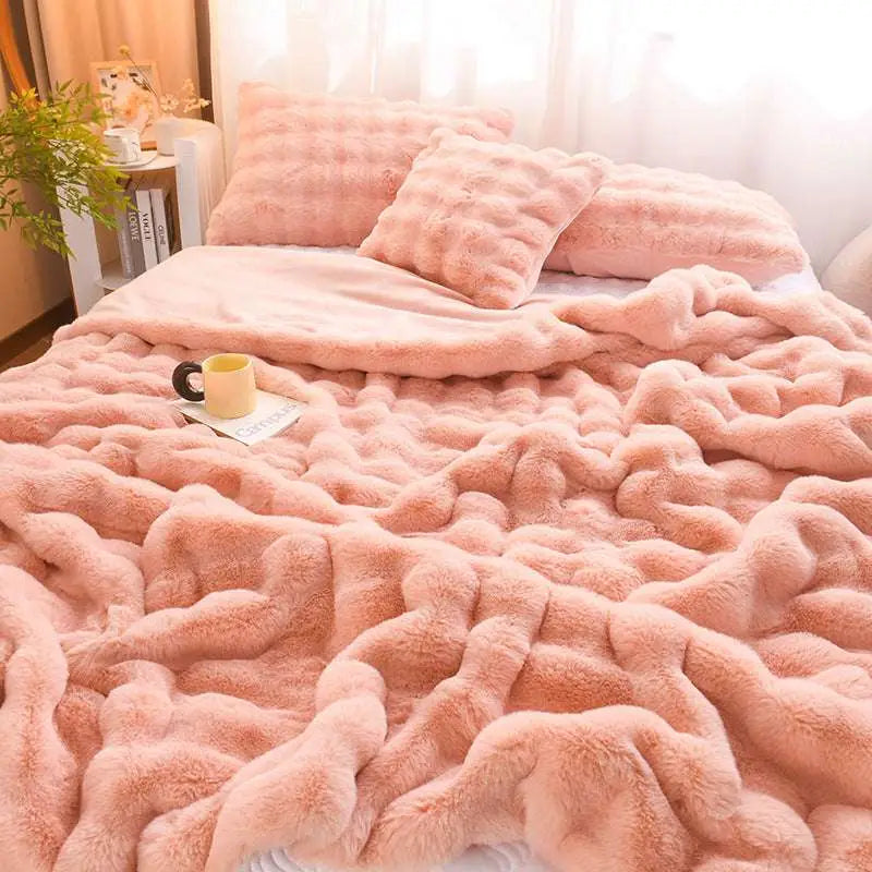 Pink faux fur throw blanket with plush textured surface and chunky knit pattern in velvet blanket thickened style