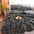 A plush gray faux fur throw with a chunky knit pattern in a thickened velvet blanket rabbit velvet blanket style