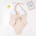Beige ribbed one-piece swimsuit with white triangle halter neck top and tied waist in plus size fashion style