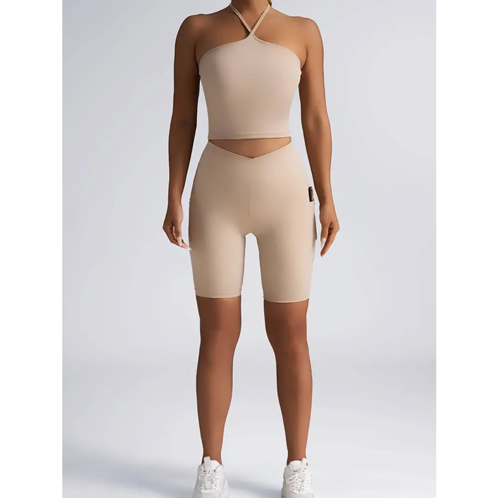 Beige ribbed high waist workout set with wide shoulder straps halter top and matching biker shorts