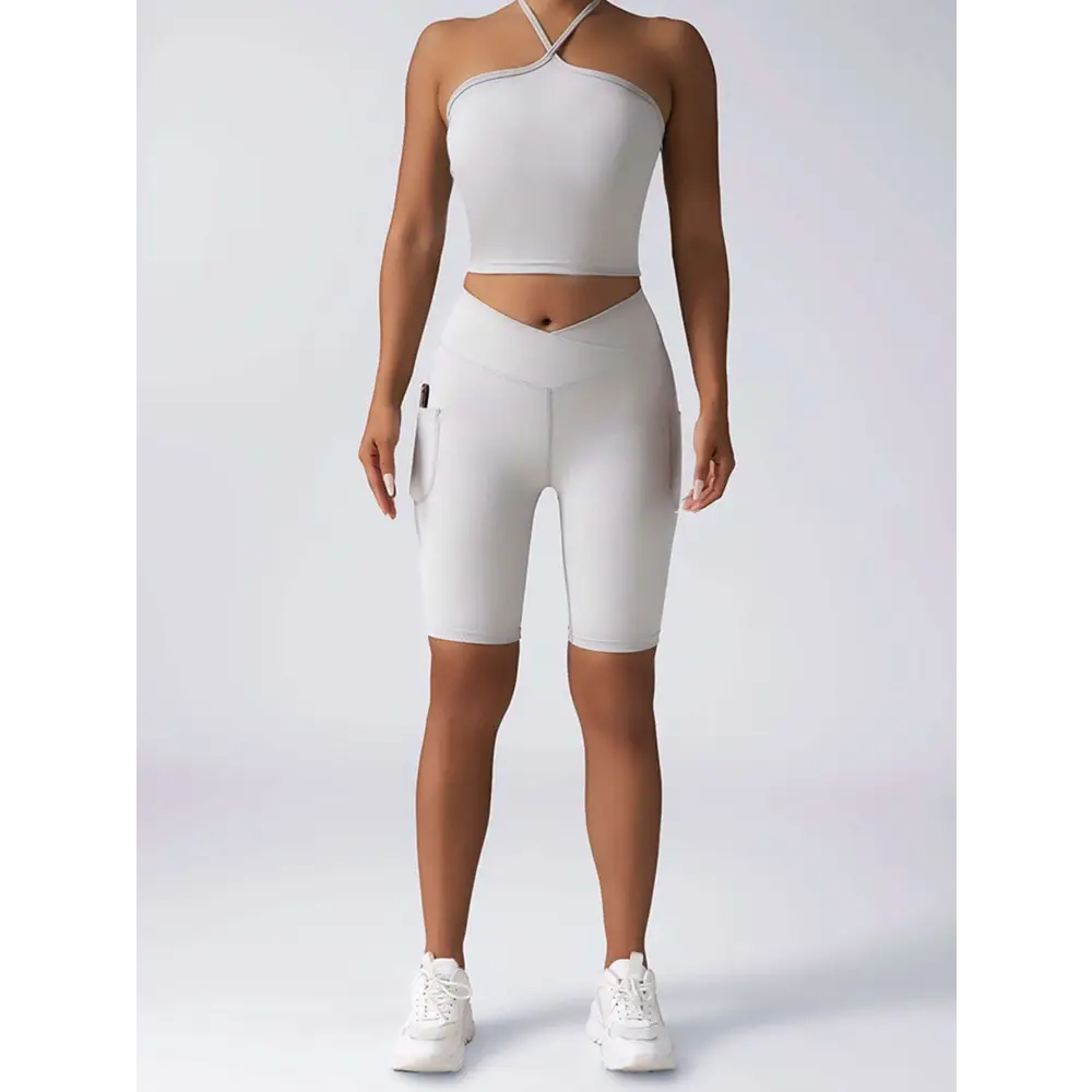 White high-waisted bike shorts with side pockets and sleek design paired with beige ribbed high waist workout set