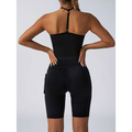 Black high-waisted biker shorts with side pockets and seamless design paired with beige ribbed high waist workout set