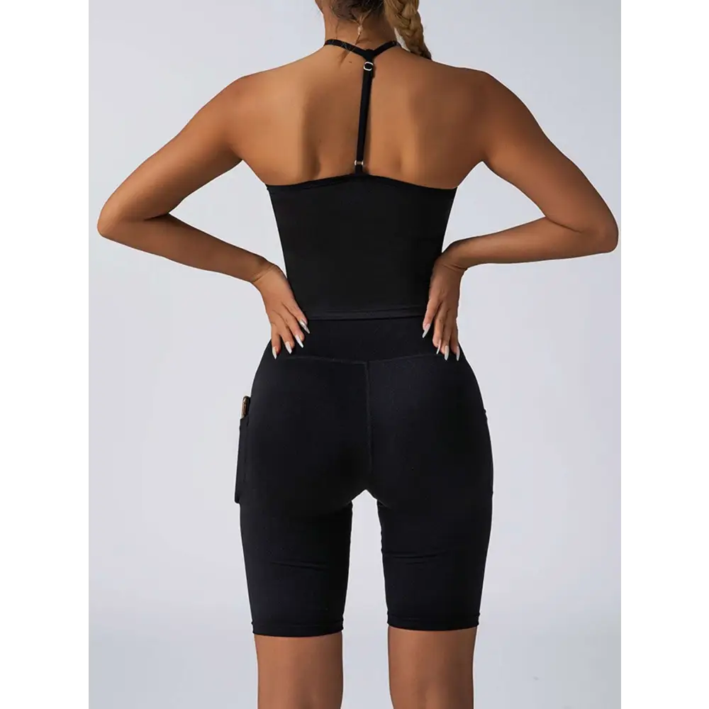 Black high-waisted biker shorts with side pockets and seamless design paired with beige ribbed high waist workout set