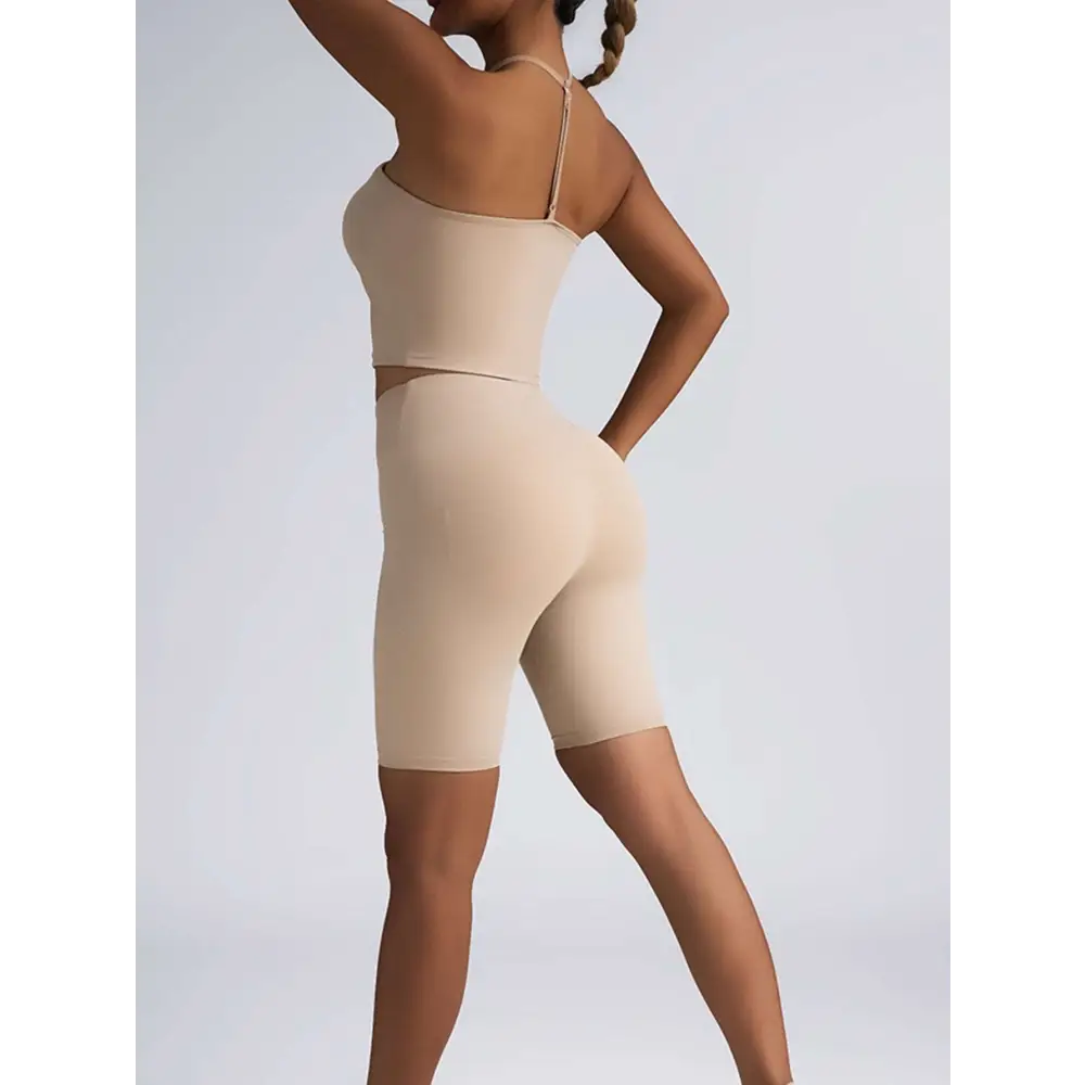 Beige ribbed two-piece high waist workout set featuring a crop top with thin straps and matching biker shorts
