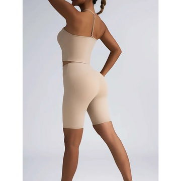 Beige ribbed two-piece high waist workout set featuring a crop top with thin straps and matching biker shorts