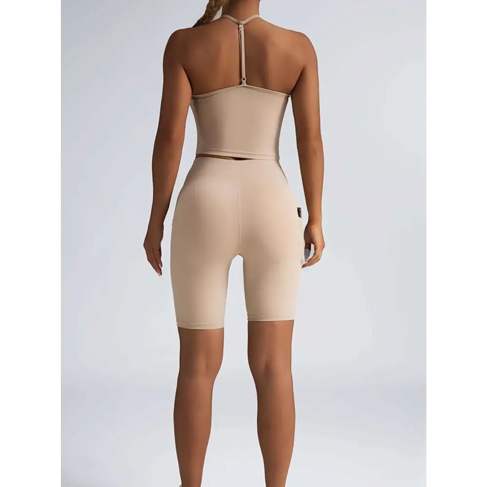 Beige ribbed high waist workout bike shorts with seamless form fitting design and small black logo on the side