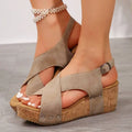 Beige suede rivet wedges snadals with cork soles and silver-toned metal accents in a fish mouth shoes design