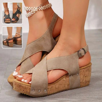 Beige suede rivet wedges snadals with cork soles and silver-toned metal accents featuring a fish mouth design